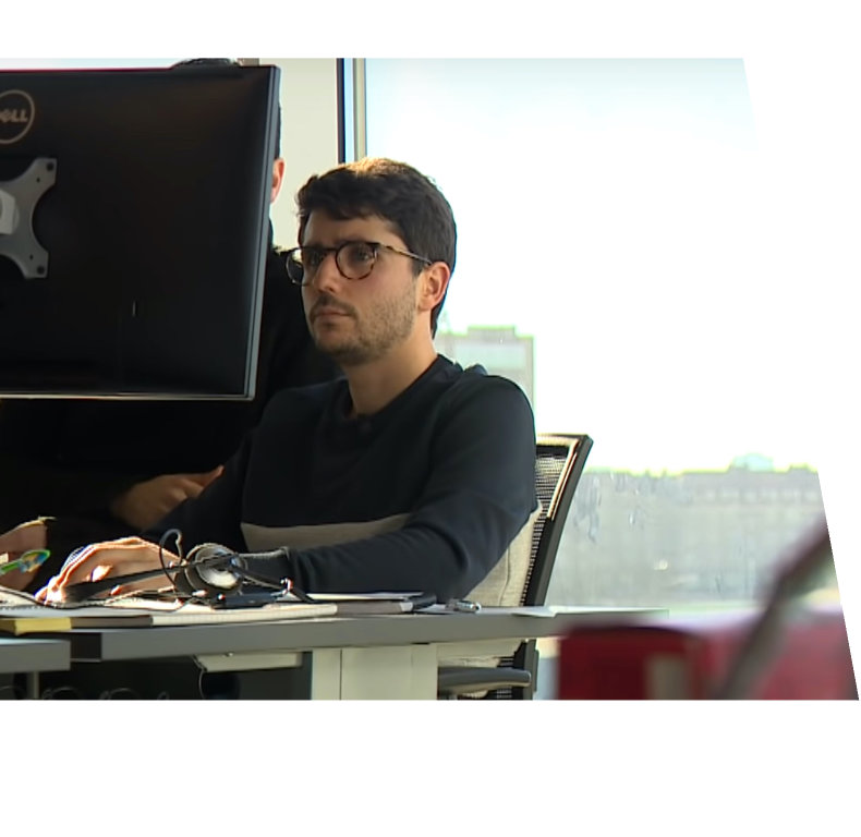 Profile Picture of Adrián Moreno (@zetxek), working side by side with a colleague: sitting on a desk, while looking at a screen